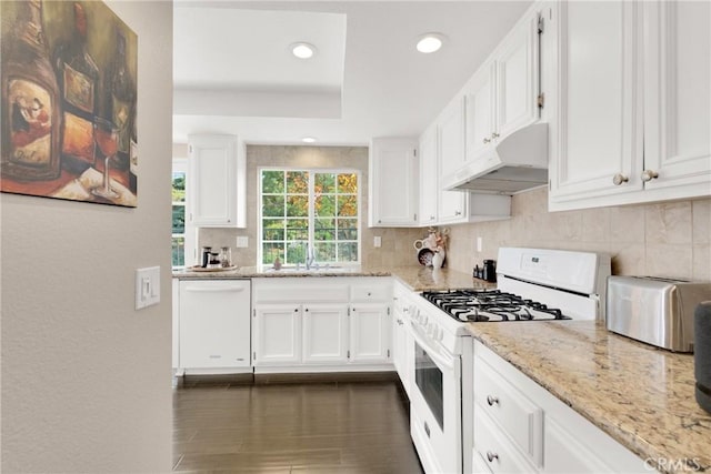 kitchen featuring white cabinets, white appliances, light stone countertops, and sink