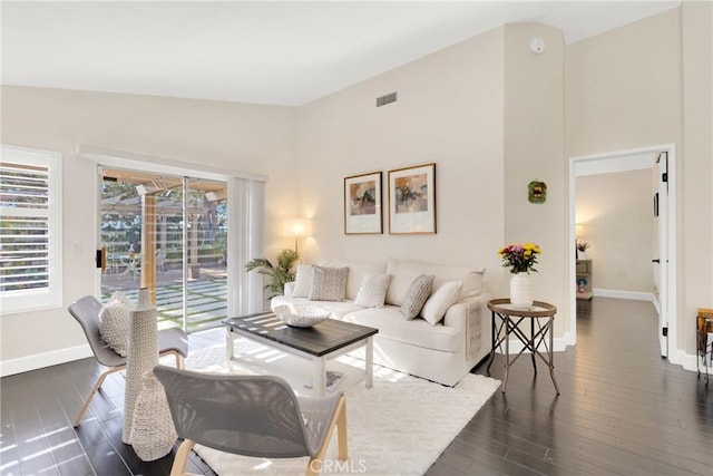 living room featuring dark hardwood / wood-style floors and lofted ceiling