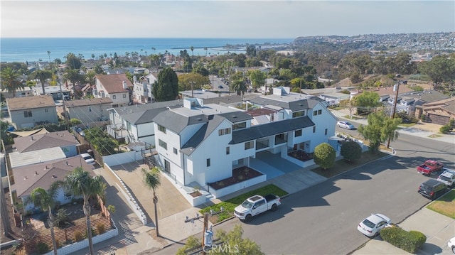 bird's eye view featuring a water view and a residential view