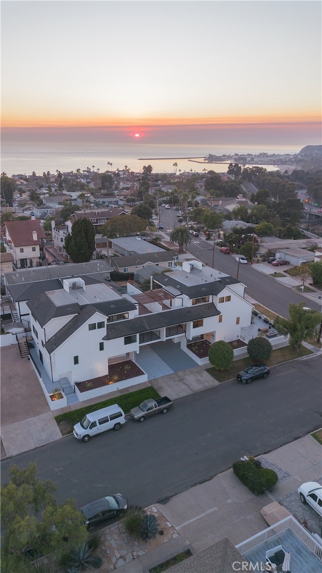 aerial view at dusk with a water view