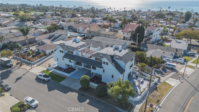 drone / aerial view featuring a water view and a residential view