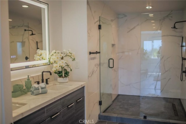 bathroom featuring vanity and an enclosed shower