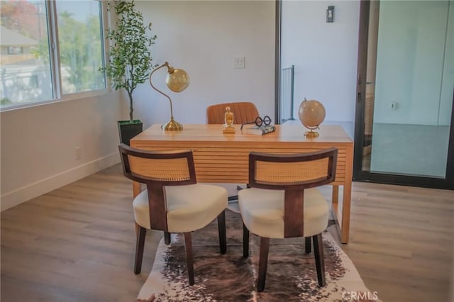 dining area with wood-type flooring