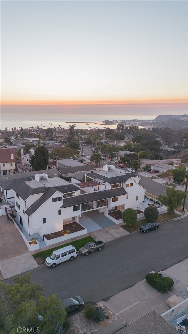 aerial view at dusk with a water view