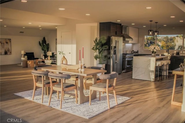 dining room featuring light hardwood / wood-style floors and sink