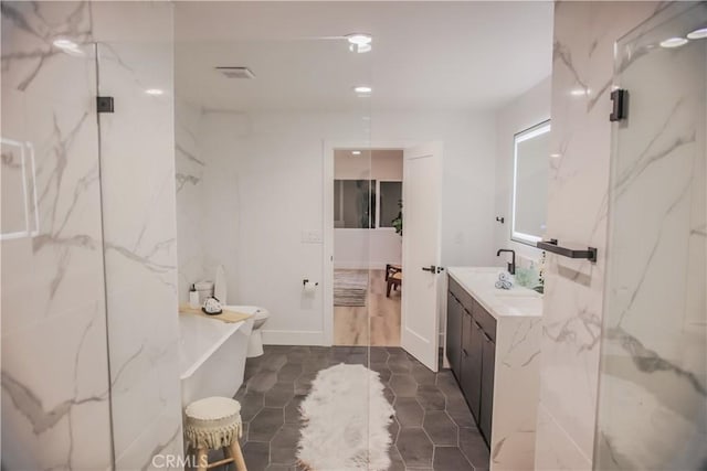 bathroom with vanity, a shower with shower door, and toilet