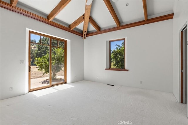 spare room featuring light carpet and lofted ceiling with beams