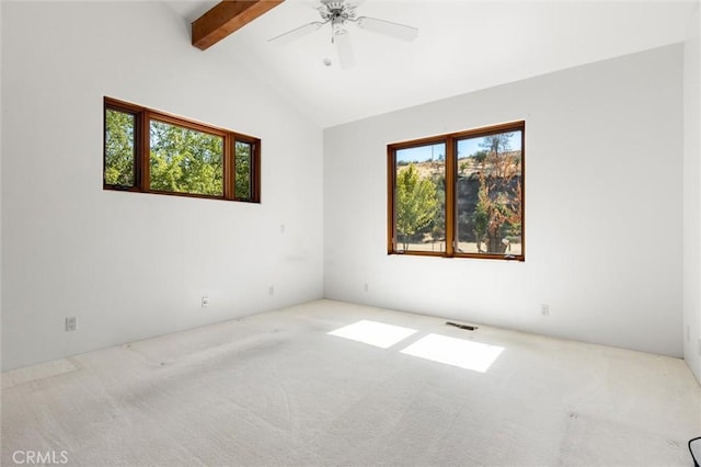 empty room with vaulted ceiling with beams, carpet floors, and a wealth of natural light