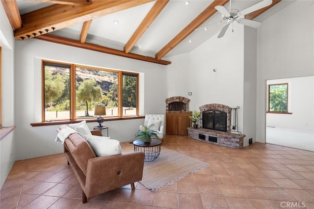 living room featuring ceiling fan, a brick fireplace, beamed ceiling, high vaulted ceiling, and light tile patterned floors