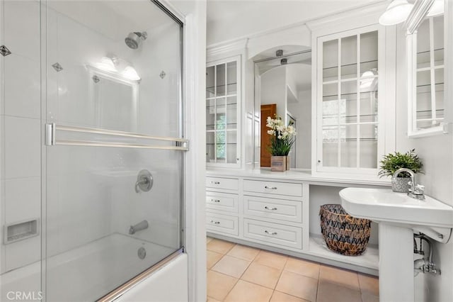 bathroom with shower / bath combination with glass door, tile patterned floors, and sink