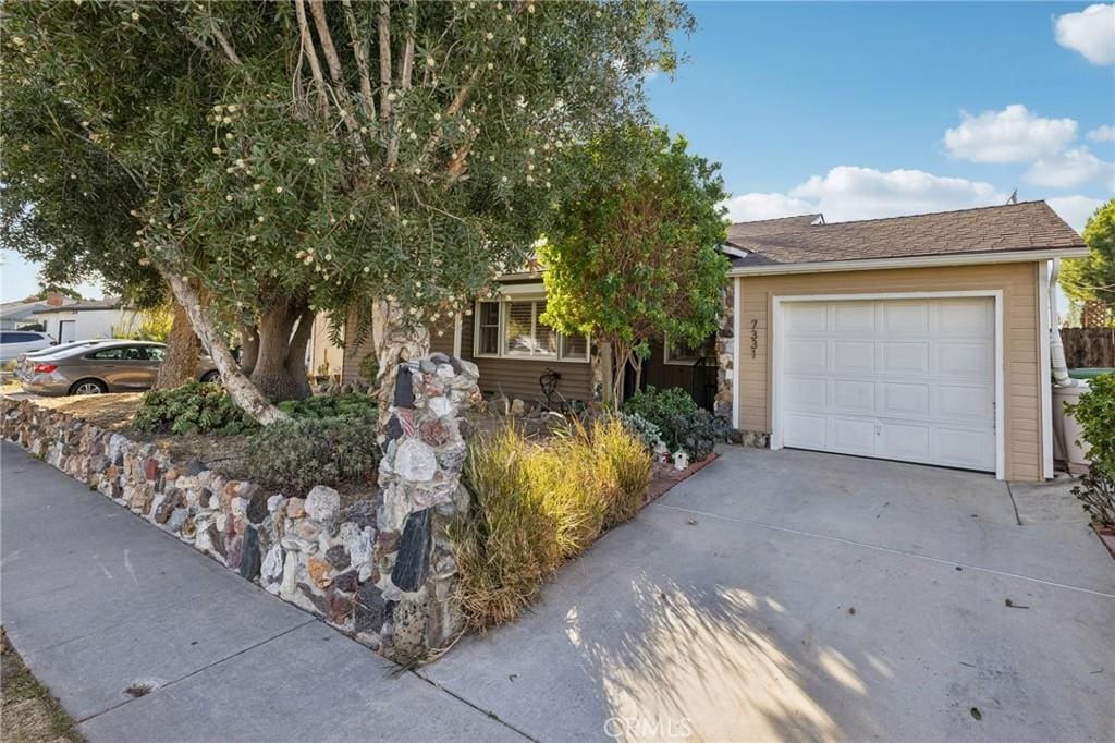 obstructed view of property with a garage