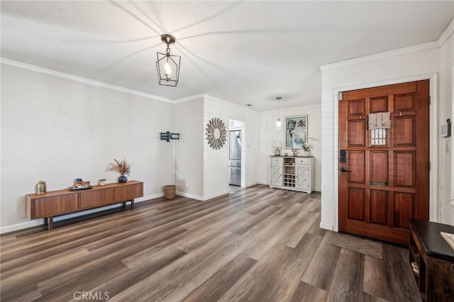 entryway with hardwood / wood-style flooring and crown molding