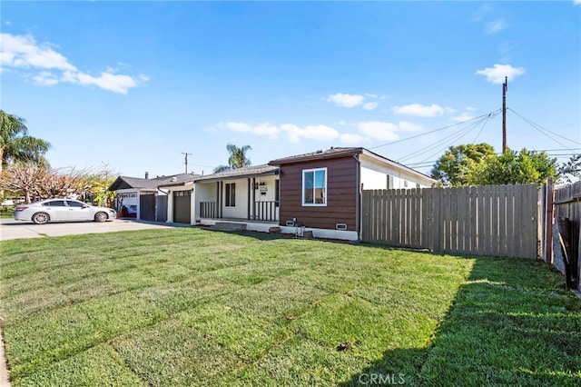 view of front of home featuring a front yard, fence, driveway, and an attached garage