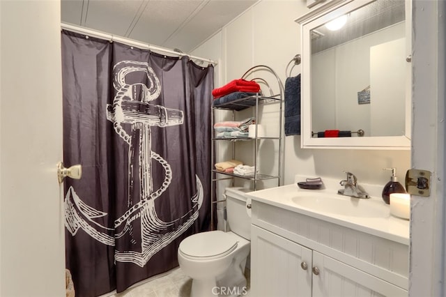 bathroom with tile patterned flooring, vanity, toilet, and curtained shower