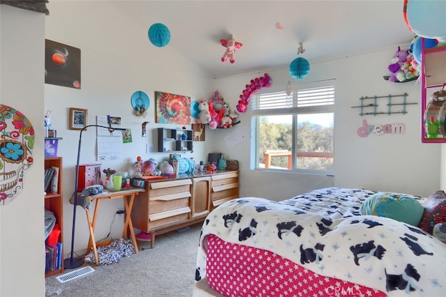 bedroom featuring carpet and vaulted ceiling