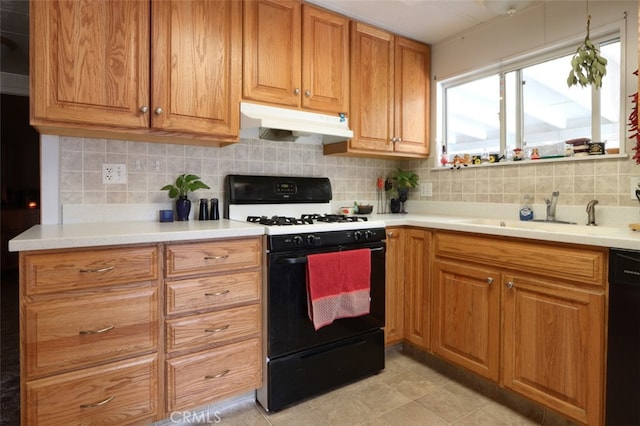 kitchen featuring black appliances, light tile patterned floors, sink, and tasteful backsplash