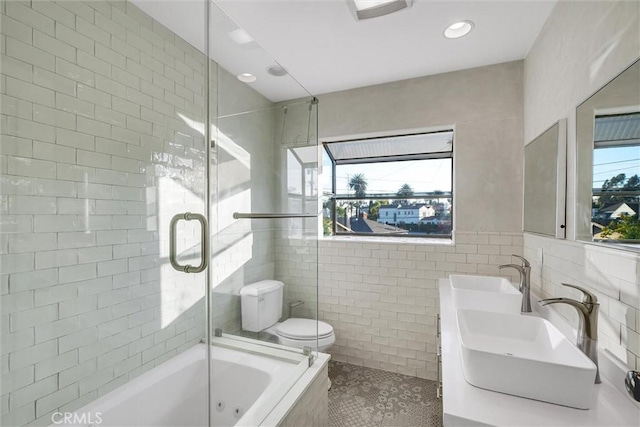 full bathroom with tile patterned flooring, tile walls, toilet, vanity, and plus walk in shower