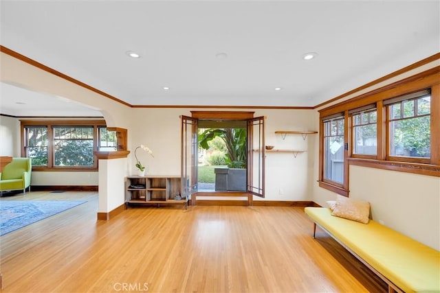 unfurnished room featuring ornamental molding and light hardwood / wood-style flooring