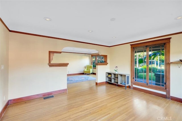 spare room featuring ornamental molding and hardwood / wood-style flooring