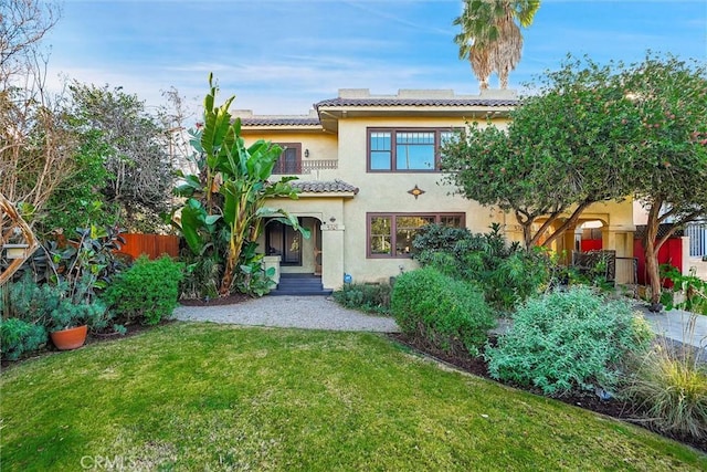 rear view of property with a lawn