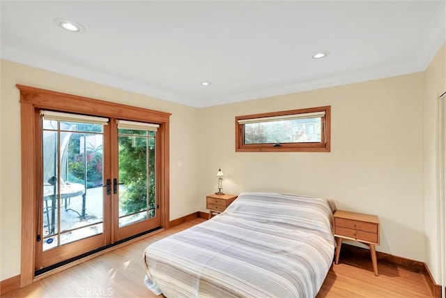 bedroom featuring light hardwood / wood-style floors, french doors, access to outside, and crown molding