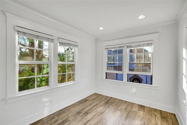 unfurnished room with wood-type flooring and ornamental molding