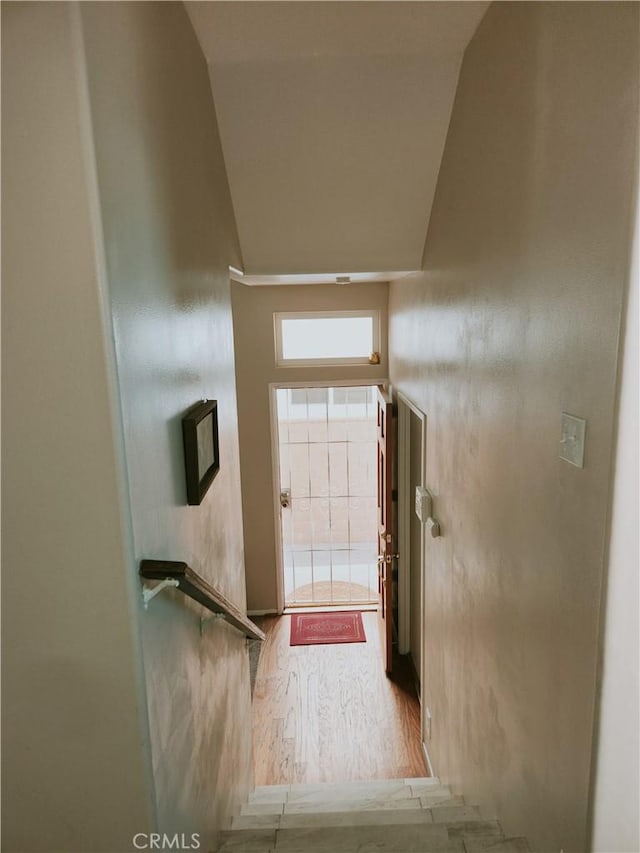 doorway to outside featuring hardwood / wood-style flooring and lofted ceiling