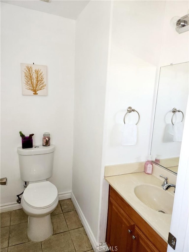 bathroom featuring tile patterned floors, vanity, and toilet