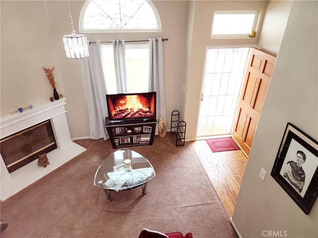 11608 Valley View Ave Unit 6, Whittier, CA 90604 - living room featuring carpet flooring, a glass covered fireplace, and an inviting chandelier