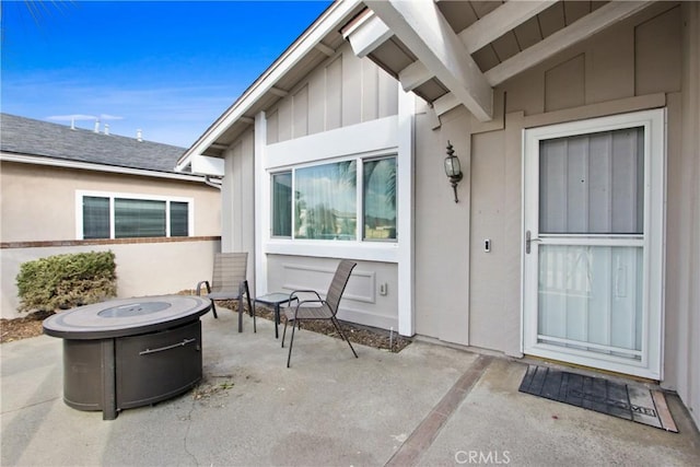 view of exterior entry featuring a patio area