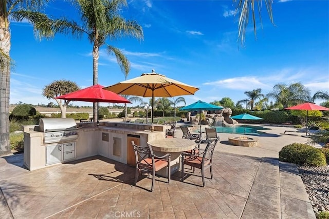 view of patio with outdoor dining area, area for grilling, and a grill