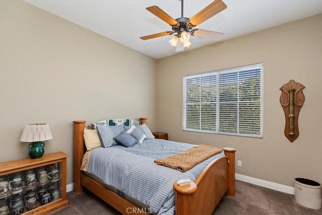 carpeted bedroom featuring a ceiling fan and baseboards