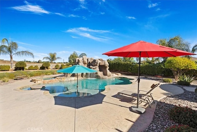 outdoor pool featuring a patio area and an in ground hot tub