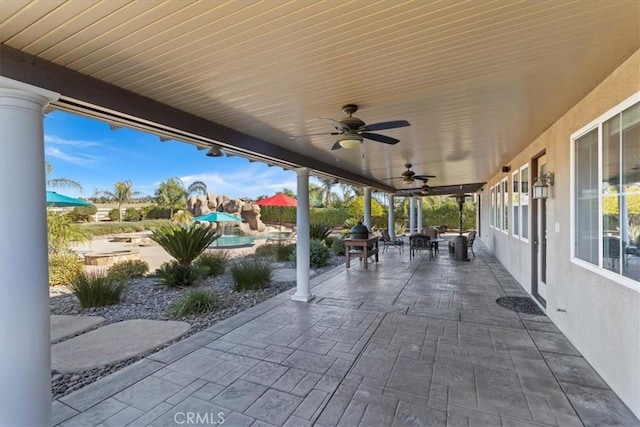 view of patio with outdoor dining space and a ceiling fan