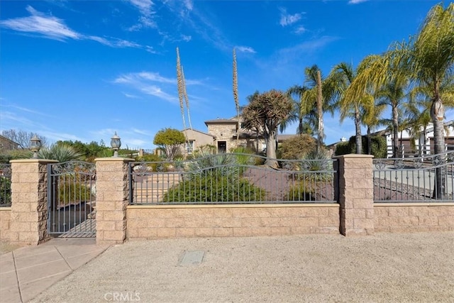 view of gate with a fenced front yard