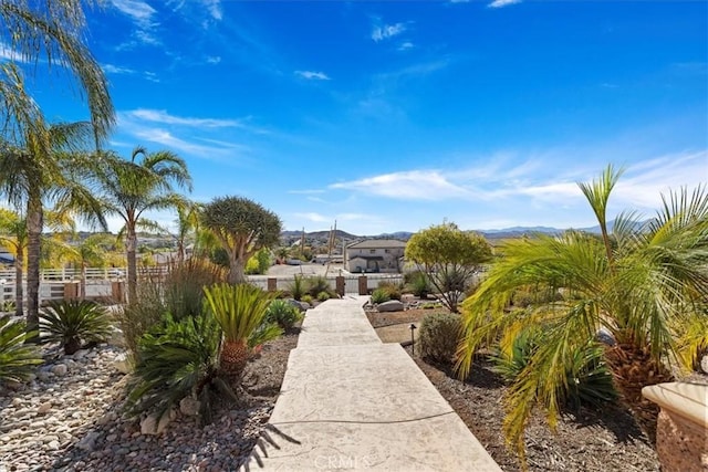 view of home's community featuring fence and a mountain view