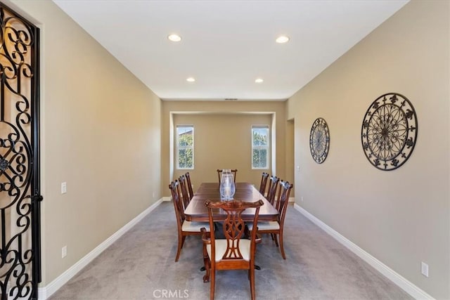 dining room featuring recessed lighting, baseboards, and light colored carpet