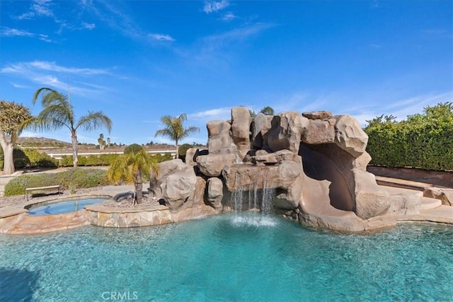 outdoor pool with an in ground hot tub