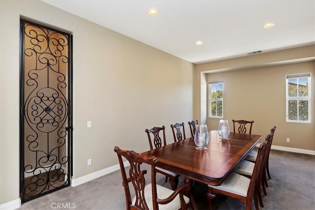 carpeted dining room featuring recessed lighting, plenty of natural light, baseboards, and visible vents