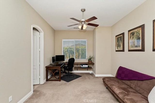 office featuring a ceiling fan, carpet, and baseboards