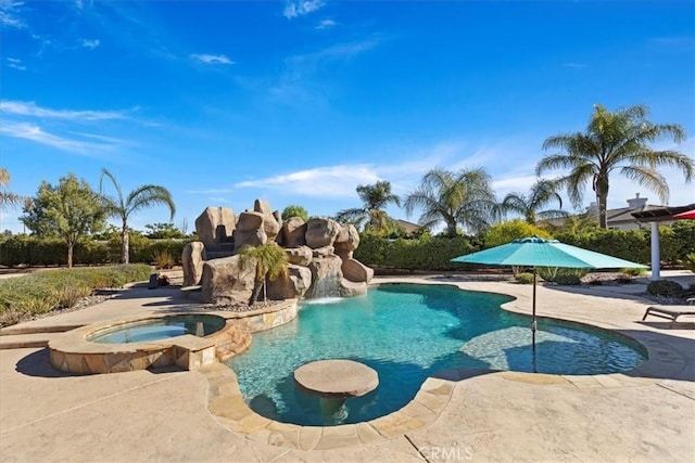 view of pool featuring a patio and a pool with connected hot tub