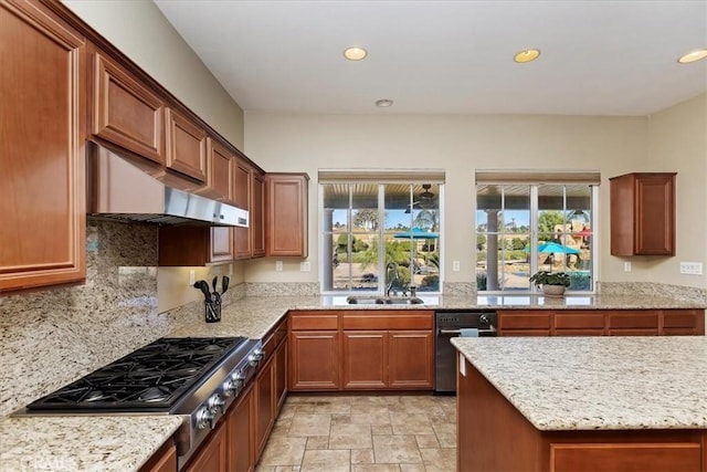 kitchen with a sink, wall chimney exhaust hood, recessed lighting, and stainless steel gas cooktop