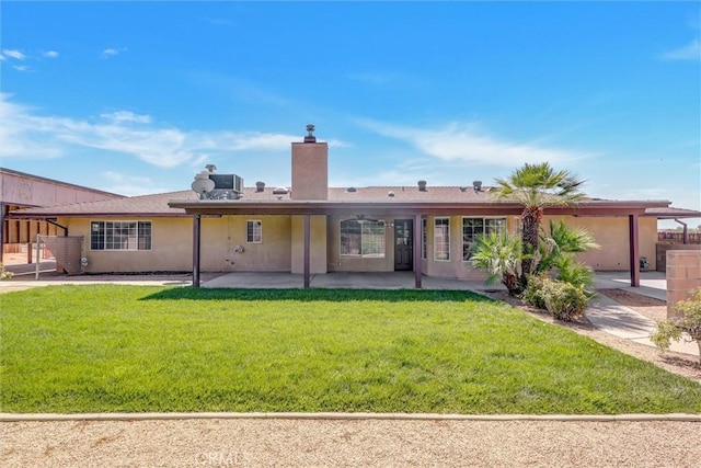 rear view of house featuring a yard and a patio area