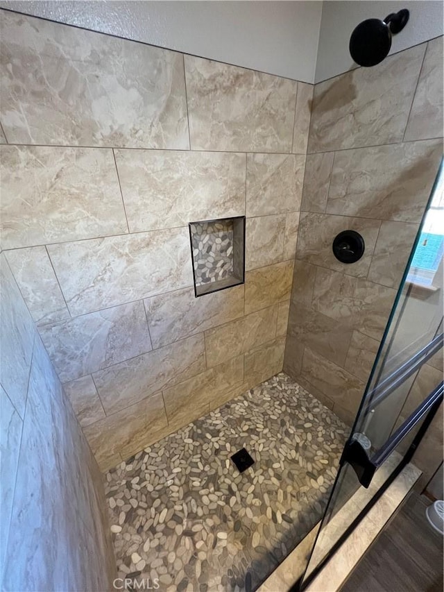 bathroom with a tile shower