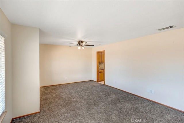 carpeted empty room featuring ceiling fan