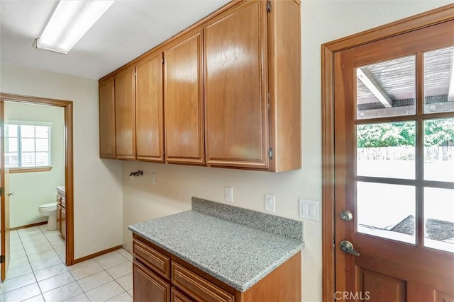 kitchen with light stone counters and light tile patterned floors