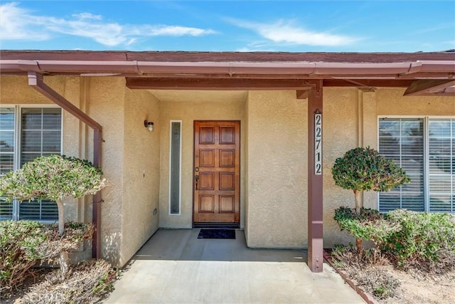 view of exterior entry with covered porch