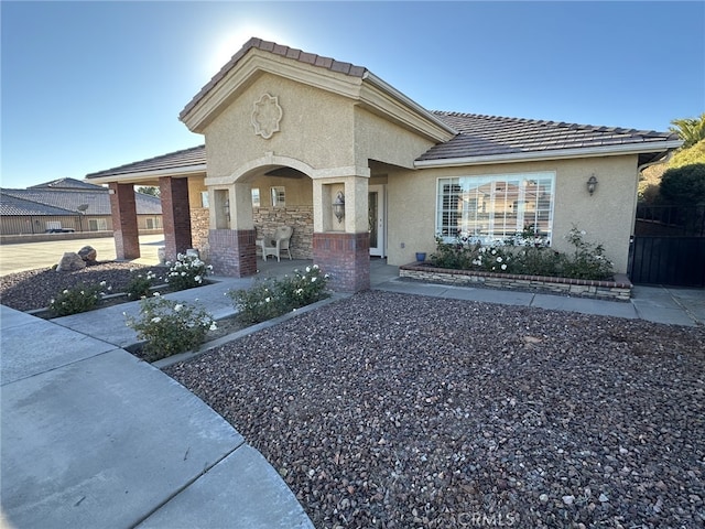 16232 Ridge View Dr, Apple Valley, CA 92307 - view of front of home featuring stucco siding, covered porch, and a tile roof