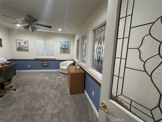 carpeted office featuring ceiling fan