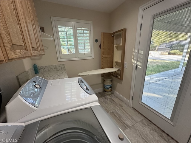 laundry area with cabinets